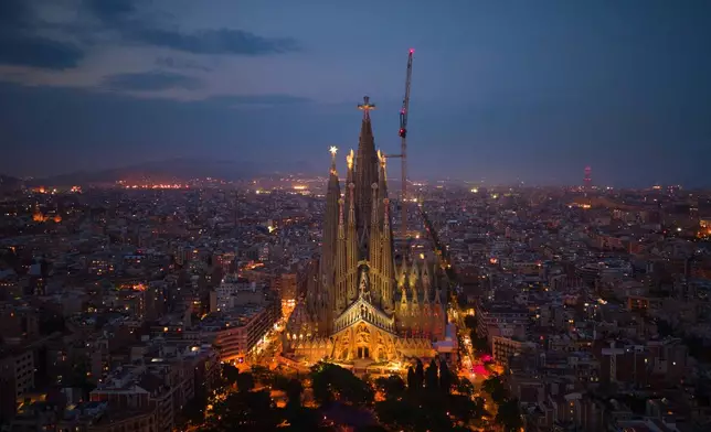 Antoni Gaudí's Basilica of the Sagrada Familia stands at dusk in Barcelona, Spain, Saturday, May 30, 2026, ahead of Pope Leo XIV's visit to Barcelona in June. (AP Photo/Emilio Morenatti)