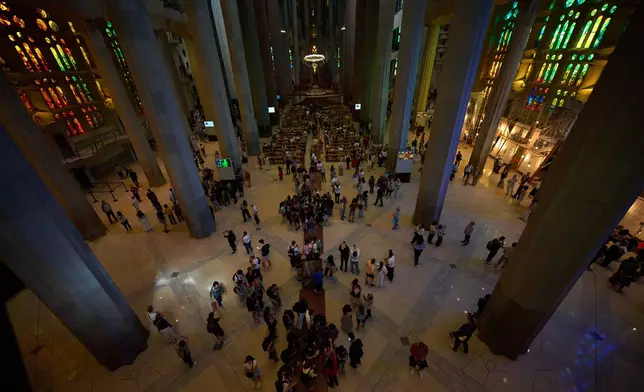 Visitors gather inside Antoni Gaudí's Sagrada Família basilica in Barcelona, Spain, Wednesday, May 20, 2026, ahead of Pope Leo XIV's visit to the city in June. (AP Photo/Emilio Morenatti)