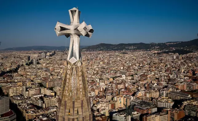 A cross crowns the 172.5-meter (566-foot) Tower of Jesus Christ at the Sagrada Familia basilica in Barcelona, Spain, Thursday, May 28, 2026, ahead of Pope Leo XIV's visit to the city in June. (AP Photo/Emilio Morenatti)
