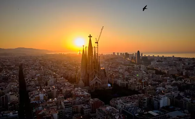 The sun rises behind Antoni Gaudí's iconic Basilica of the Sagrada Familia in Barcelona, Spain, Thursday, May 28, 2026, ahead of Pope Leo XIV's visit to the city in June. (AP Photo/Emilio Morenatti)