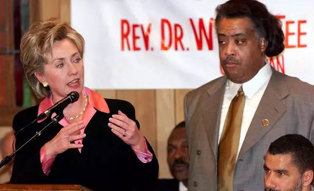 FILE - First lady Hillary Rodham Clinton delivers her speech at the National Action Network's Annual Martin Luther King Jr. Public Policy Forum as, from left, Assemblyman Keith Wright, Rev. Al Sharpton, and State Senator David Paterson look on Monday, Jan. 17, 2000, in New York. (AP Photo/Kathy Willens, File)