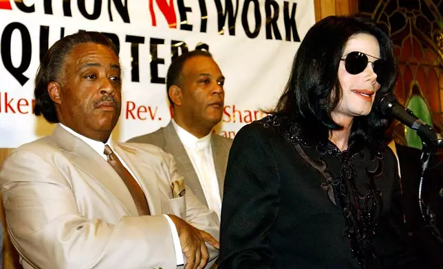 FILE - Singer Michael Jackson, right, speaks to the crowd at Rev. Al Sharpton's National Action Network headquarters, Saturday, July 6, 2002 in Harlem, New York, as Rev. Sharpton, left, listens. (AP Photo/Stephen Chernin, File)