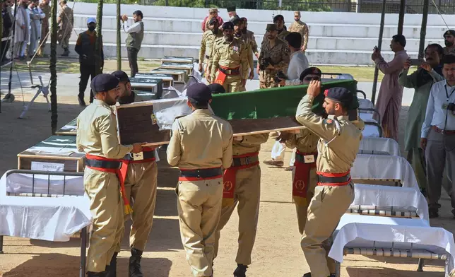 Army soldiers carry a flag-wrapped casket of military personnel, killed in the Wednesday's helicopter crashed, during a funeral prayer, in Muzaffarabad, the capital of Pakistan-administered Kashmir, Thursday, June 11, 2026. (AP Photo/M.D. Mughal)