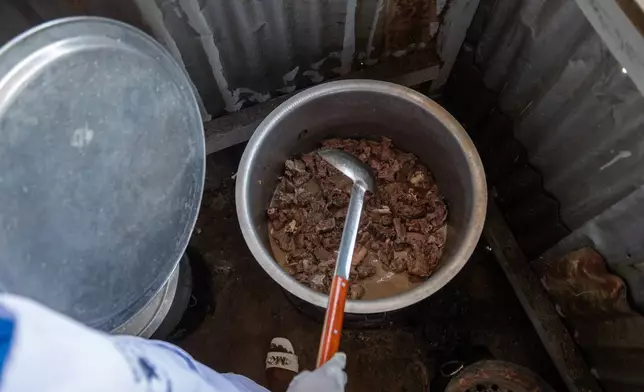 Arlette Basekawike prepares meals for Ebola patients at the Evangelical Medical Center (CEM) in Bunia, Congo, Monday, June 1, 2026. (AP Photo/Moses Sawasawa)