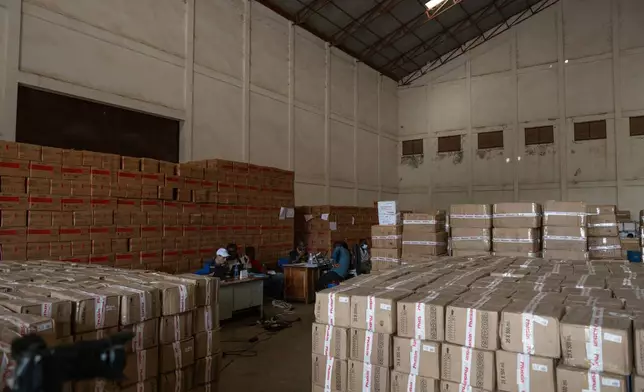People work at the World Food Programme (WFP) warehouse where supplies for the Ebola response are kept in Bunia, Congo, Monday, June 1, 2026. (AP Photo/Moses Sawasawa)