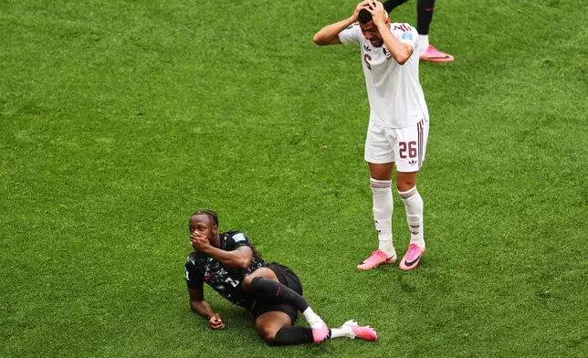 Qatar's Mohamed Manai (26) reacts after Canada's Ismael Kone (8) was injured on a dangerous play during the World Cup Group B soccer match between Canada and Qatar in Vancouver, British Columbia, Thursday, June 18, 2026. (AP Photo/Kaleb Tatum)