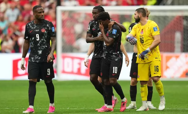 Canada's Jonathan David, third from left, becomes emotional after Ismael Kone sustained an injury and was taken off the field during the World Cup Group B soccer match against Qatar in Vancouver, British Columbia, Thursday, June 18, 2026. (AP Photo/Abbie Parr)