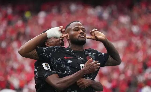 Canada's Cyle Larin (9) celebrates after scoring his sides opening goal during World Cup Group B soccer match between Canada and Qatar in Vancouver, British Columbia, Thursday, June 18, 2026. (Darryl Dyck/The Canadian Press via AP)