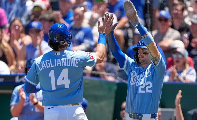 Kansas City Royals' Jac Caglianone (14) celebrates with Carter Jensen (22) after they both scored on a two-run double hit by Maikel Garcia during the third inning of a baseball game against the Houston Astros, Sunday, June 14, 2026, in Kansas City, Mo. (AP Photo/Charlie Riedel)