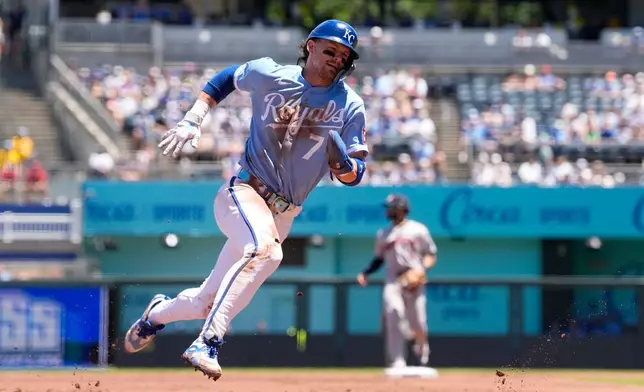 Kansas City Royals' Bobby Witt Jr., rounds third as he runs home to score on a single by Maikel Garcia during the first inning of a baseball game against the Houston Astros, Sunday, June 14, 2026, in Kansas City, Mo. (AP Photo/Charlie Riedel)