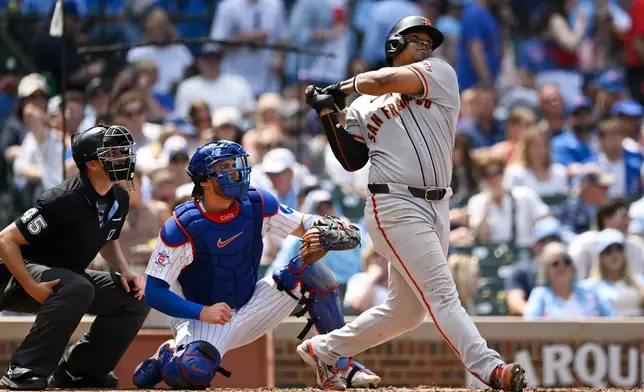 San Francisco Giants' Rafael Devers hits a solo home run during the sixth inning of a baseball game against the Chicago Cubs in Chicago, Saturday, June 6, 2026. (AP Photo/Paul Beaty)