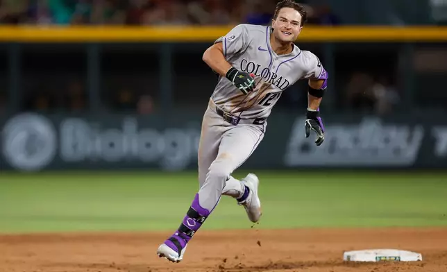 Colorado Rockies' Kyle Karros rounds second base as he makes his way to third base after hitting a triple during the fifth inning of a baseball game against the Athletics, Saturday, June 13, 2026, in Las Vegas. (AP Photo/Caroline Brehman)