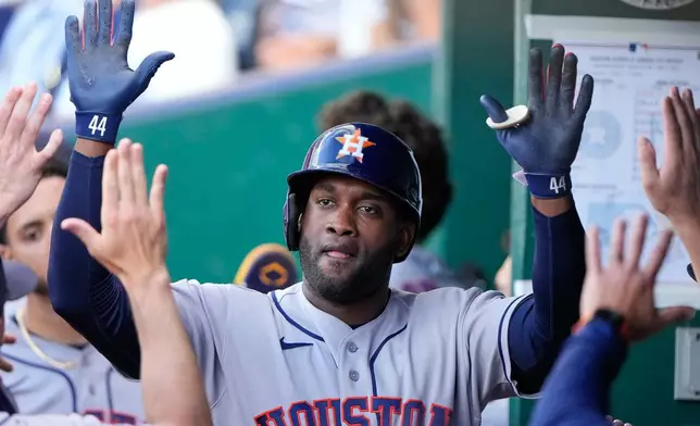 Houston Astros' Yordan Alvarez celebrates in the dugout after hitting a two-run home run hit during the first inning of a baseball game against the Kansas City Royals, Friday, June 12, 2026, in Kansas City, Mo. (AP Photo/Charlie Riedel)