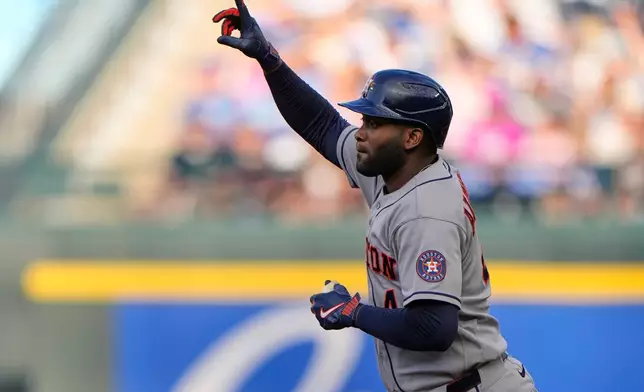 Houston Astros' Yordan Alvarez celebrates after hitting a two-run home run during the first inning of a baseball game against the Kansas City Royals, Friday, June 12, 2026, in Kansas City, Mo. (AP Photo/Charlie Riedel)