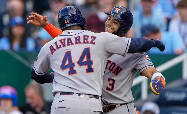 Houston Astros' Yordan Alvarez (44) celebrates with Jeremy Pena (3) after hitting a two-run home run during the first inning of a baseball game against the Kansas City Royals, Friday, June 12, 2026, in Kansas City, Mo. (AP Photo/Charlie Riedel)