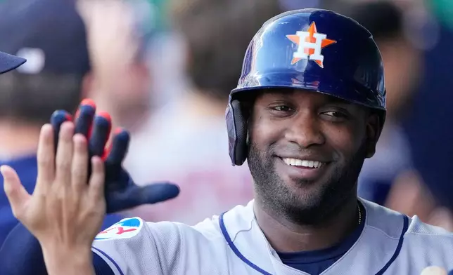 Houston Astros' Yordan Alvarez celebrates in the dugout after hitting a grand slam during the first inning of a baseball game against the Kansas City Royals, Friday, June 12, 2026, in Kansas City, Mo. (AP Photo/Charlie Riedel)