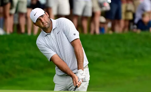 Scottie Scheffler hits at the 15th hole during the third round of the Travelers Championship golf tournament at TPC River Highlands, Saturday, June 27, 2026, in Cromwell, Conn. (AP Photo/Jessica Hill)