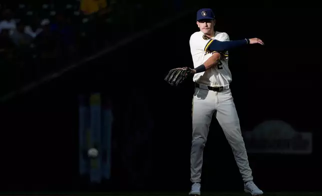 Milwaukee Brewers' Cooper Pratt warms up before the first inning of a baseball game against the Cleveland Guardians, Tuesday, June 16, 2026, in Milwaukee. (AP Photo/Aaron Gash)