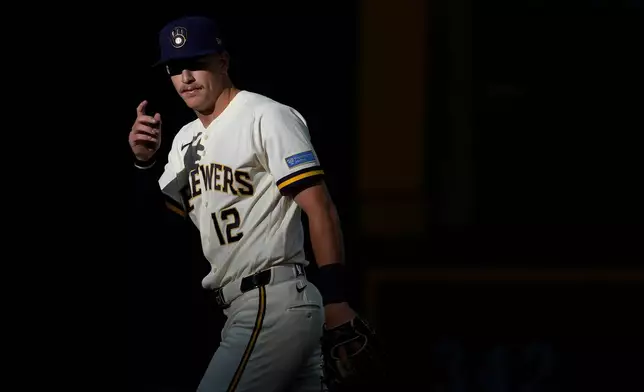 Milwaukee Brewers' Cooper Pratt warms up before the first inning of a baseball game against the Cleveland Guardians, Tuesday, June 16, 2026, in Milwaukee. (AP Photo/Aaron Gash)