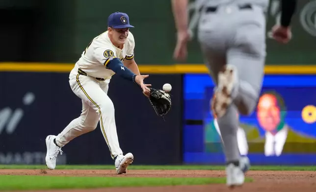Milwaukee Brewers' Cooper Pratt tosses the ball to second base to start a double play during the second inning of a baseball game against the Cleveland Guardians, Tuesday, June 16, 2026, in Milwaukee. (AP Photo/Aaron Gash)