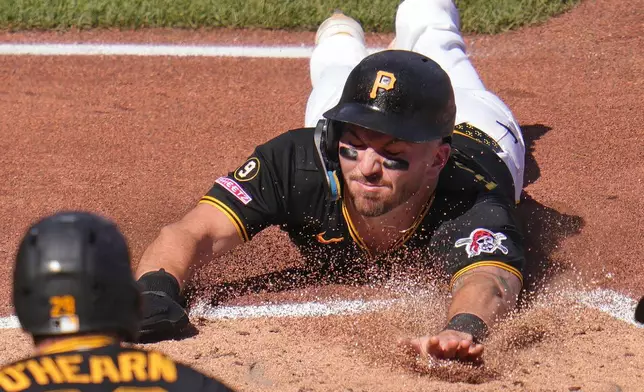 Pittsburgh Pirates' Spencer Horwitz, right, scores on a double by Bryan Reynolds off Miami Marlins pitcher John King during the third inning of a baseball game in Pittsburgh, Saturday, June 13, 2026. (AP Photo/Gene J. Puskar)