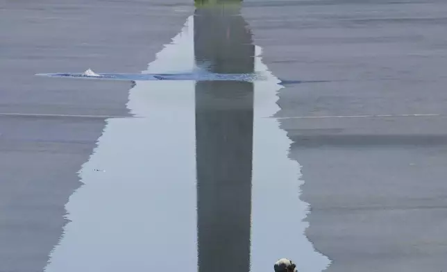 A worker walks through water as it flows into the Lincoln Memorial Reflecting Pool, ahead of the United States 250th anniversary, Thursday, June 4, 2026, in Washington. (AP Photo/Rod Lamkey, Jr.)