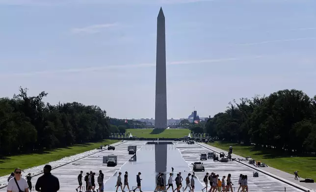 The Lincoln Memorial Reflecting Pool is being refilled after several months of repairs on Friday, June 5, 2026, in Washington, with the Washington Monument in the background. (AP Photo/Rahmat Gul)