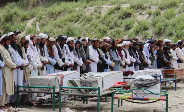 Mourners pray during a funeral for victims, including children, of airstrikes that Taliban officials said were carried out by Pakistan, in Mana, a village in Afghanistan's Khost province, Wednesday, June 10, 2026. (AP Photo/Saifullah Zahir)