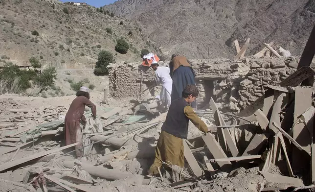 Residents go through the rubble after what Taliban officials said was airstrikes carried out by Pakistan, and killed civilians, including children, in Mana, a village in Afghanistan's Khost province, Wednesday, June 10, 2026. (AP Photo/Saifullah Zahir)