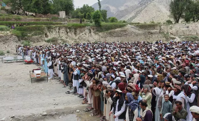 Mourners pray during a funeral for victims, including children, of airstrikes that Taliban officials said were carried out by Pakistan, in Mana, a village in Afghanistan's Khost province, Wednesday, June 10, 2026. (AP Photo/Saifullah Zahir)