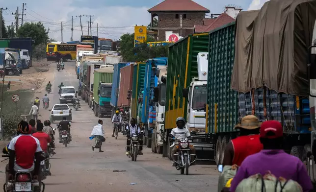 Cargo trucks queue up at the Mpondwe border crossing linking Uganda and the Democratic Republic of the Congo, Thursday, June 4, 2026. (AP Photo/Hajarah Nalwadda)