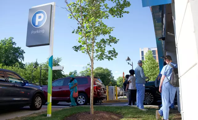 People stand in the perimeter of Wilmington Hospital in the aftermath of a shooting on Tuesday, June 16, 2026, in Wilmington, Del. (AP Photo/Mingson Lau)