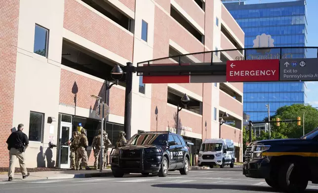 Law enforcement personnel stage outside of Wilmington Hospital in the aftermath of a shooting on Tuesday, June 16, 2026, in Wilmington, Del. (AP Photo/Mingson Lau)