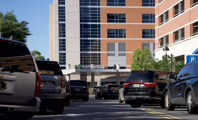 Emergency vehicles are parked outside of Wilmington Hospital in the aftermath of a shooting on Tuesday, June 16, 2026, in Wilmington, Del. (AP Photo/Mingson Lau)