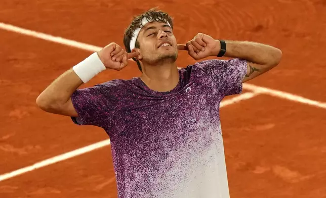 Italy's Flavio Cobolli reacts after winning the quarterfinal tennis match against Canada's Felix Auger-Aliassime at the French Open in Paris, Wednesday, June 3, 2026. (AP Photo/Aurelien Morissard)