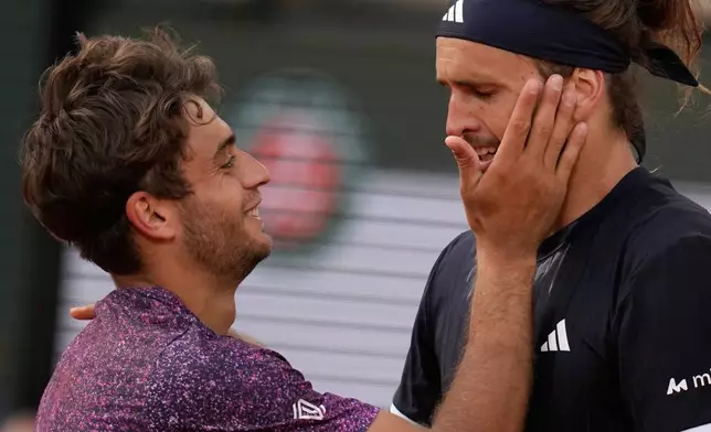 Second placed Flavio Cobolli of Italy, left, greets winner Alexander Zverev of Germany after their men's final match at the French Open tennis tournament in Paris, Sunday, June 7, 2026. (AP Photo/Christophe Ena)