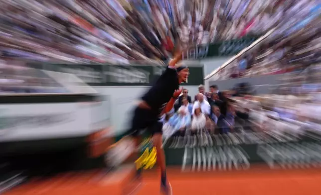 Germany's Alexander Zverev serves to Czech Republic's Jakub Mensik during the semifinal tennis match at the French Open in Paris, Friday, June 5, 2026. (AP Photo/Christophe Ena)