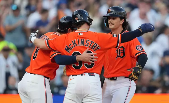 Detroit Tigers' James Outman, right, celebrates his three-run home run with Matt Vierling (8) and Zach McKinstry (39) against the Houston Astros during the fourth inning of a baseball game Friday, June 26, 2026, in Detroit. (AP Photo/Paul Sancya)