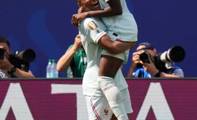 France's Ousmane Dembele (7), right, celebrates with France's Kylian Mbappe (10) after scoring his side's third goal during the World Cup Group I soccer match between Norway and France in Foxborough, Mass., near Boston, Friday, June 26, 2026. (AP Photo/Charles Krupa)