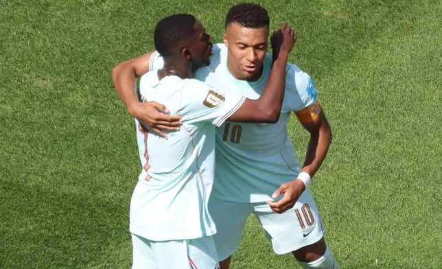France's Kylian Mbappe (10) and Ousmane Dembele (7) celebrate after scoring during the World Cup Group I soccer match between Norway and France in Foxborough, Mass., near Boston, Friday, June 26, 2026. (AP Photo/Mark Stockwell)