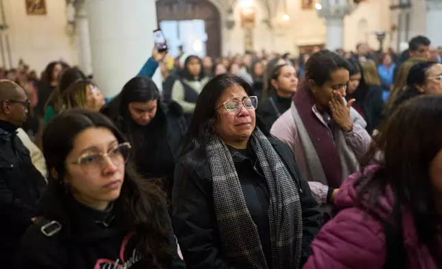 People attend a mass to honor the victims of the earthquakes in Venezuela, in Buenos Aires, Argentina, Thursday, June 25, 2026. (AP Photo/Rodrigo Abd)