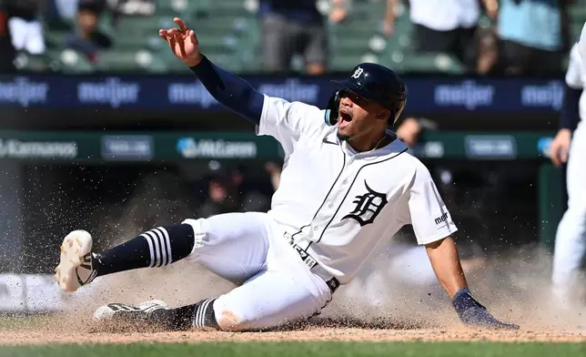 Detroit Tigers' Wenceel Pérez celebrates as he slides across home plate with the game-winning run against the Seattle Mariners in the ninth inning of a baseball game, Sunday, June 7, 2026, in Detroit. (AP Photo/Lon Horwedel)