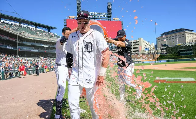 Detroit Tigers' Kevin McGonigle, center, gets doused with a bucket of Gatorade from teammates Riley Greene, left, and Jahmai Jones after driving in two runs with a walk-off single against the Seattle Mariners in the ninth inning of a baseball game, Sunday, June 7, 2026, in Detroit. (AP Photo/Lon Horwedel)