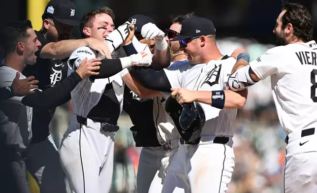 Detroit Tigers' Kevin McGonigle, third from left, celebrates with his teammates Spencer Torkelson, center right, and Matt Vierling, right, after hitting a two-run walk-off single against the Seattle Mariners in the ninth inning of a baseball game, Sunday, June 7, 2026, in Detroit. (AP Photo/Lon Horwedel)