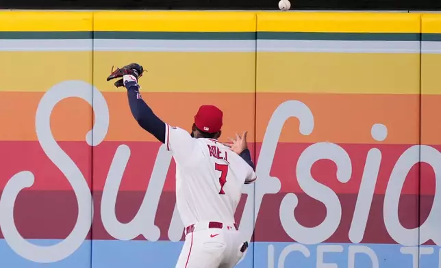 Los Angeles Angels right fielder Jo Adell misplays a ball hit by Colorado Rockies' TJ Rumfield that hit him in the head and then bounced out for a solo home run during the fourth inning of a baseball game Tuesday, June 2, 2026, in Anaheim, Calif. (AP Photo/Mark J. Terrill)