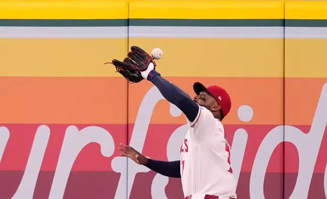 Los Angeles Angels right fielder Jo Adell misplays a ball hit by Colorado Rockies' TJ Rumfield that hit him in the head and then bounced out for a solo home run during the fourth inning of a baseball game Tuesday, June 2, 2026, in Anaheim, Calif. (AP Photo/Mark J. Terrill)