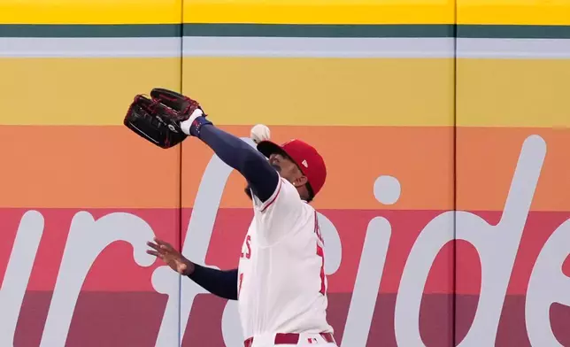 Los Angeles Angels right fielder Jo Adell misplays a ball hit by Colorado Rockies' TJ Rumfield that hit him in the head and then bounced out for a solo home run during the fourth inning of a baseball game Tuesday, June 2, 2026, in Anaheim, Calif. (AP Photo/Mark J. Terrill)