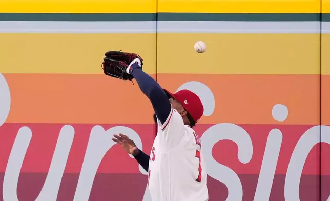 Los Angeles Angels right fielder Jo Adell misplays a ball hit by Colorado Rockies' TJ Rumfield that hit him in the head and then bounced out for a solo home run during the fourth inning of a baseball game Tuesday, June 2, 2026, in Anaheim, Calif. (AP Photo/Mark J. Terrill)