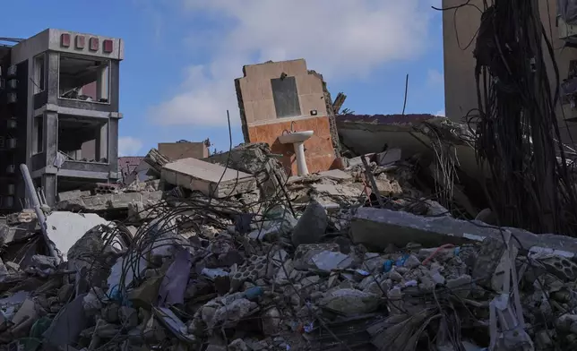 A bathroom mirror and sink remain standing amid the rubble of buildings damaged by Israeli strikes near the Jabal Amel Hospital in the southern port city of Tyre, Lebanon, Thursday, June 18, 2026. (AP Photo/Hassan Ammar)