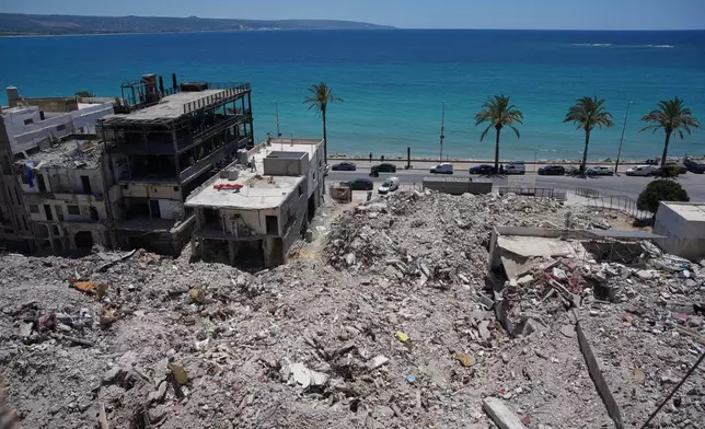 A general view shows rubble from buildings destroyed in Israeli strikes along the waterfront in the southern port city of Tyre, Lebanon, Friday, June 19, 2026. (AP Photo/Hassan Ammar)